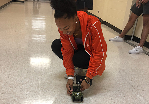 In Kathy Wilsons physics class, sophomore Carmen White sets up the car to see how long it takes to travel from start to finish.