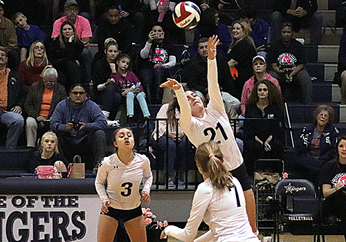 While freshman Madi Dennis set up the ball Oct. 19 at home, seniors Ashley Acuna and Tara McLeod get into position in the 3-0 win over San Marcos.