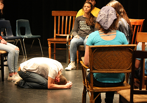 In a state of mourning, George Gibbs, portrayed by freshman Jackson Posey, crumbles on stage during Our Town, showing now through Saturday in the auditorium.