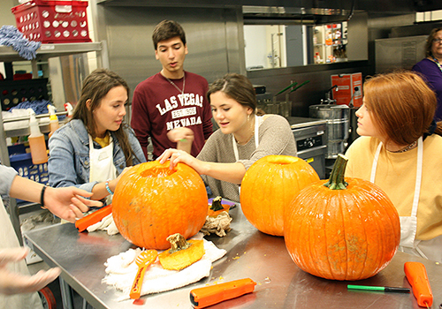 One day before Halloween, students in Margaret Marruccis culinary class carve pumpkins in the Blue Star Cafe.