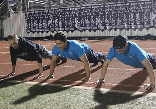 On senior night for football, dance and cheer Nov. 2, ROTC cadets senior Logan Dean, junior Cade Molina and senior Jackson Richmond count out pushups, one for each point scored by the football team.