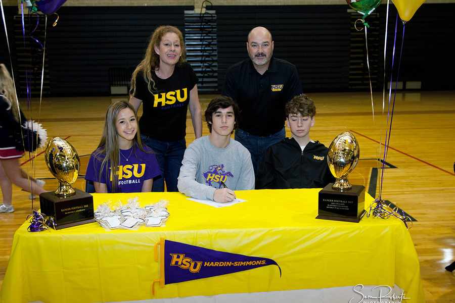 With his family by his side, Christian Romano signs his letter of intent to play football at Hardin-Simmons University.