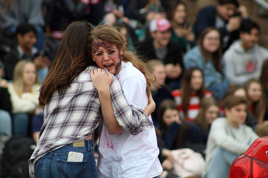 Kailey Fox hangs onto Meagan Sturm after an accident simulated during the Shattered Dreams presentation.
