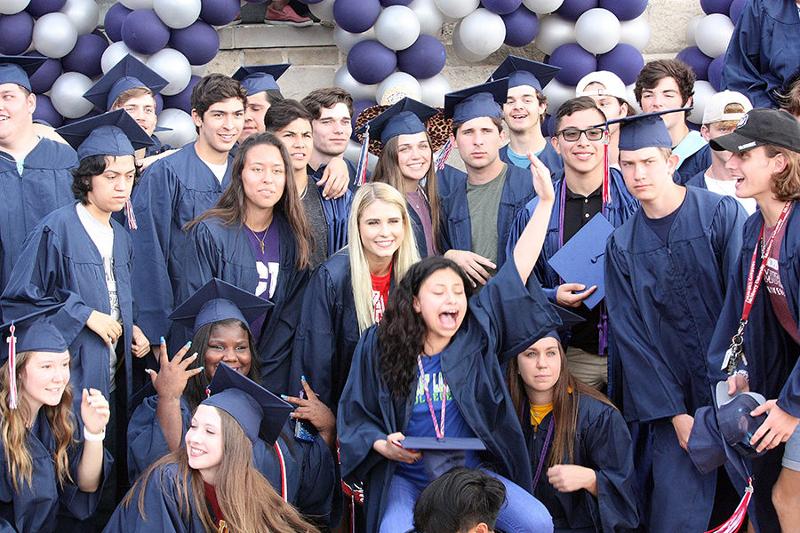 A group pose turns into a hoopla after the senior walk.