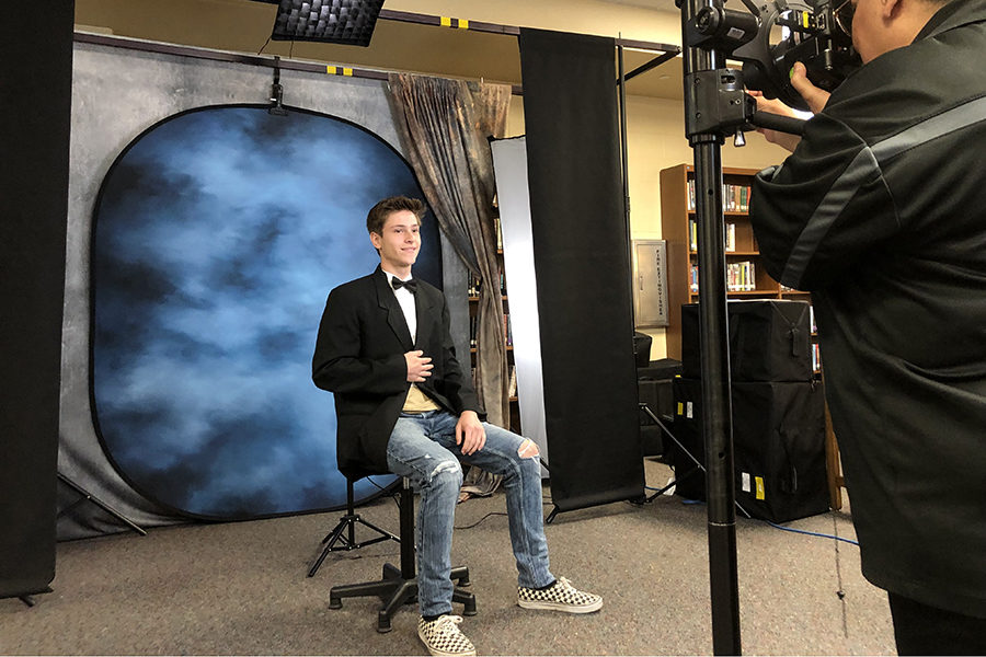 After donning his tux, senior David Drewfs gets ready for his senior portrait in the library. Seniors who have not taken their portraits for the yearbook are encouraged to go by the library any time Tuesday to take care of that, no appointment necessary.