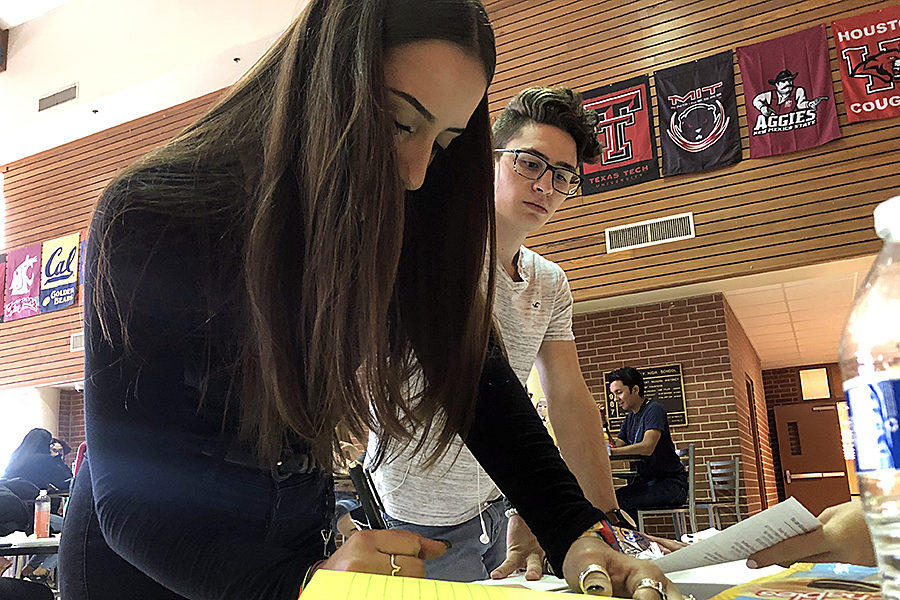 During lunch in the senior dining hall, junior Raquel Knez signs the dotted line committing to donating one pint of blood during the Oct. 2 blood drive in front of the school. FACS will sign up donors through Sept. 27. For information, go to C106.