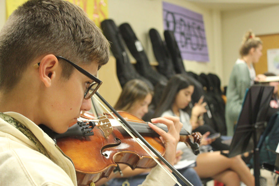 Wyatt Sedlak warms up on his violin during second period orchestra.