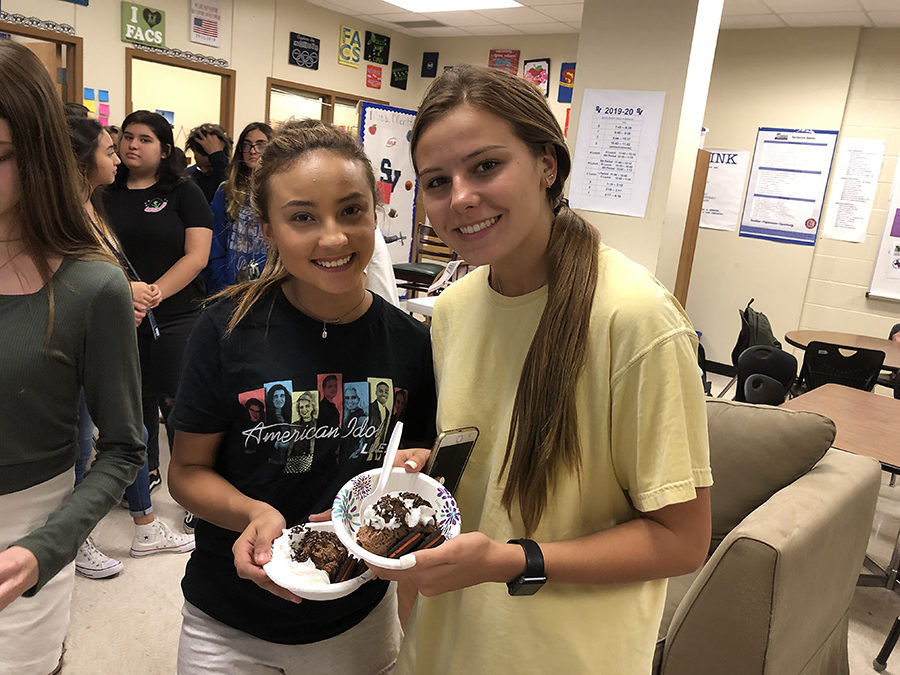 At the FCCLA ice cream social today after school, Brandy Ruiz and Naomi Morrow fill their bowls and pile on the toppings while learning more about the organization.