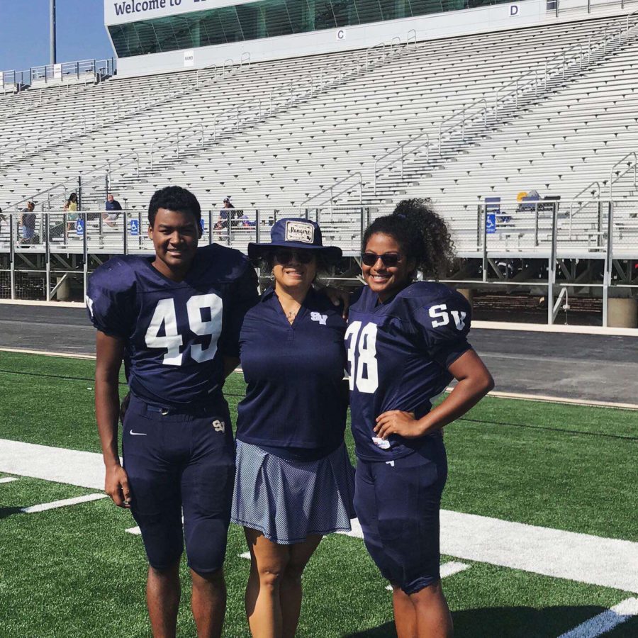  Sifuentes-Shaffer (right) smiles with her mother and brother at Football Barbecue Day. Selena plays fullback for the junior varsity team.