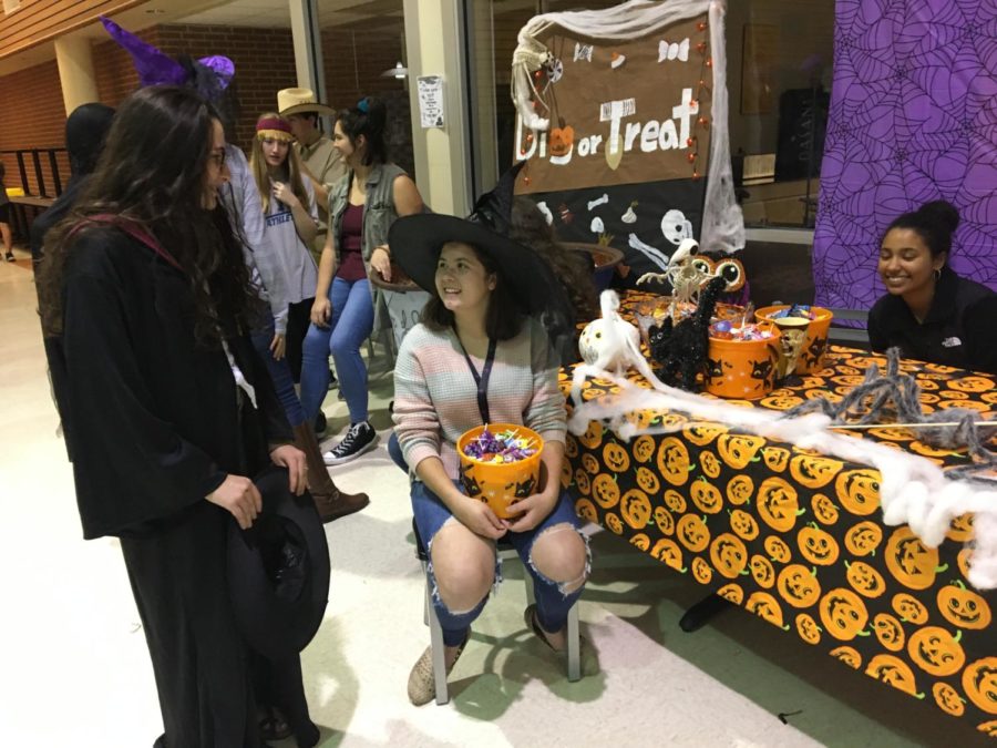 Sort of entertaining, Humans of SV members Madison Hodges and Emma Leos wait to use the sorting hat on trick-or-treater at their booth.