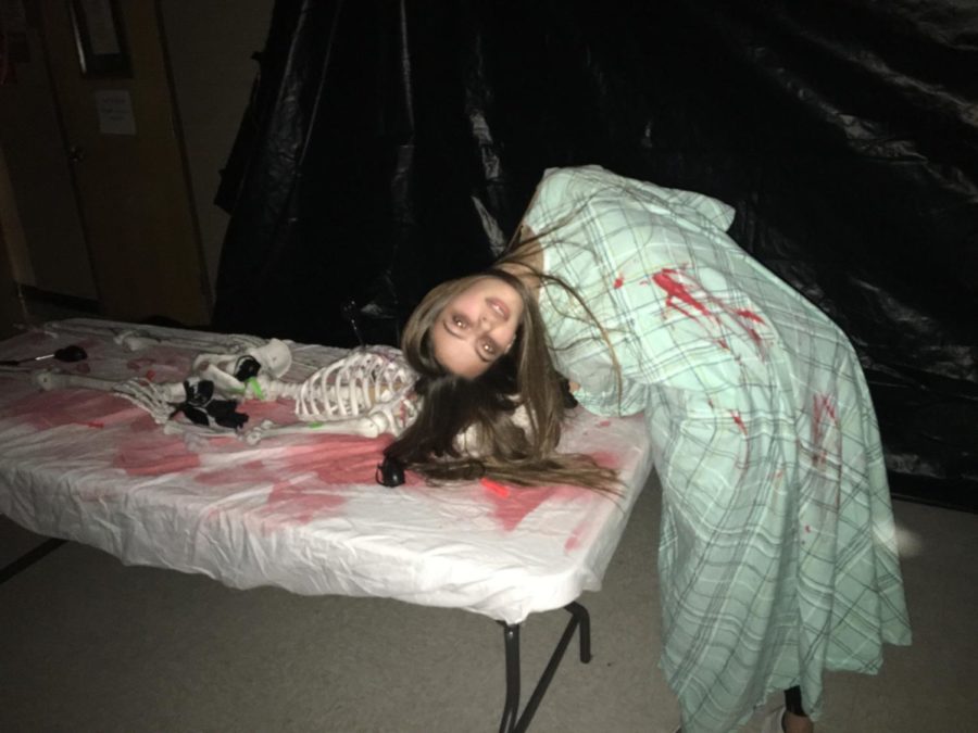 Senior Jasmine Green distorts her scary self in the haunted house.