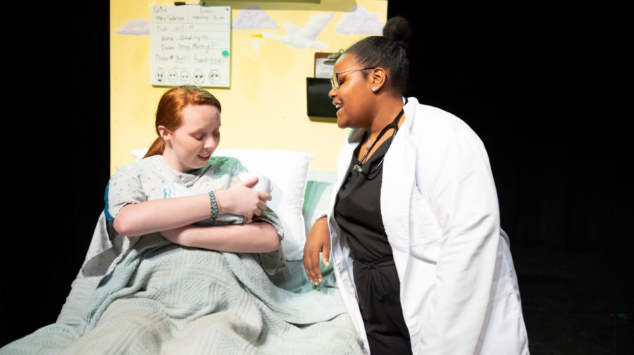 After the hospital prop is built, Junior Brenna Collins and freshman Chaya Powell rehearse a scene from Middletown.