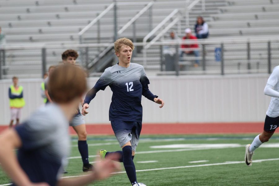 Senior Brett Dildy dribbles down the pitch. Dildy, a midfielder, has a goal and two assists to his name this season.