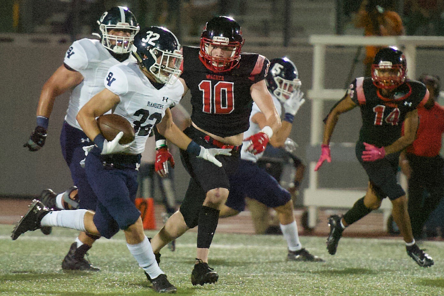 Travis McCracken evades tacklers against Wagner. McCracken rushed for 93 yards and two touchdowns Thursday night against South San.