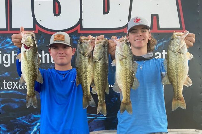 At Lake LBJ on Nov. 14, Mason McClellan and Ryder Cunningham show off the fish they caught as members of the Comal ISD Bass Fishing Club They took sixth place at the tournament.