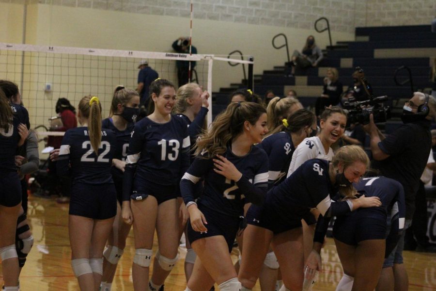 The volleyball team celebrates a big win against Wagner on Senior Night 