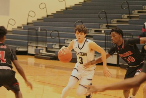 Senior Cody Garcia maneuvers around two Wagner defenders. Garcia averaged 7.7 points per game this season and led the team in assists.