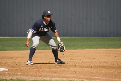 John Garza prepares to charge a ground ball. Garza, a breakout third baseman, has played a key role in baseball’s 11-game winning streak.