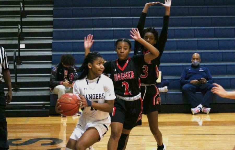 Trinity Garrett looks to pass the ball under pressure from Wagner. Garrett averaged 10 points per game this season, and she signed to play basketball at the University of South Alabama in the fall.