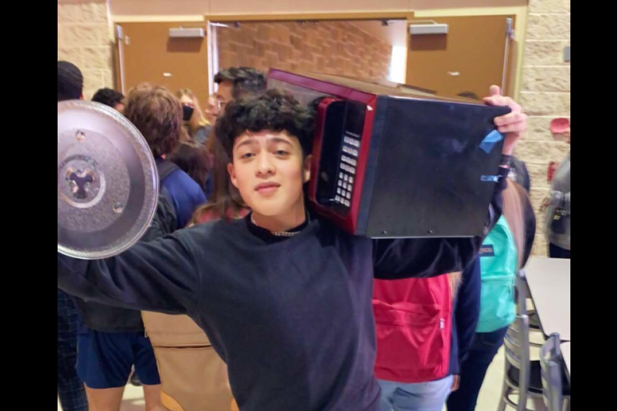 Daniel Diaz brings a microwave to school for anything but a backpack day. Other students brought household items as well.
