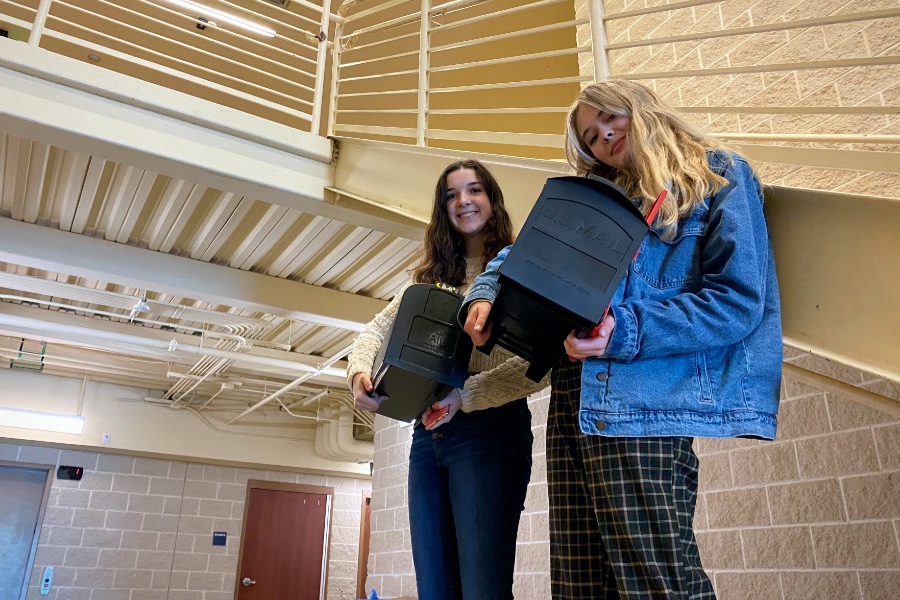 Standing outside the auditorium, Ellie Seamster and Morgan Miller show off their mailboxes on Anything but a Backpack Day. The two collaborated on the project, which garnered lots of attention from classmates.