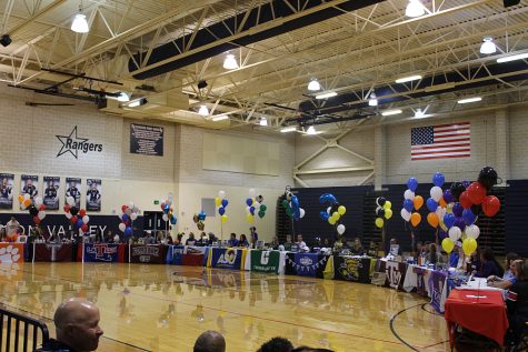 Fourteen athletes sign their commitments to compete at the collegiate level on Wednesday in the main gym.