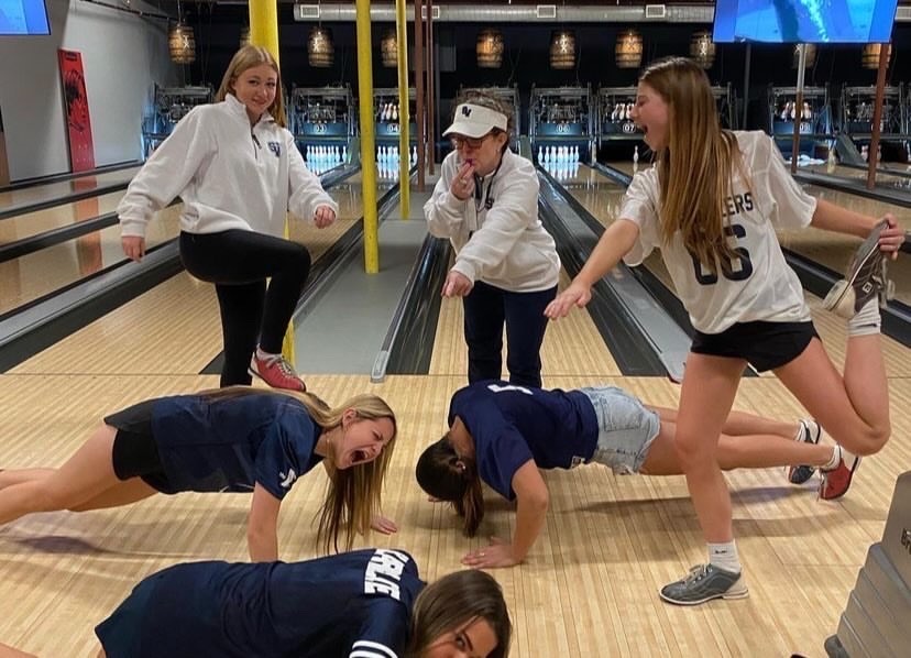 Varsity cheer team participates in team bonding to boost morale before competition.
