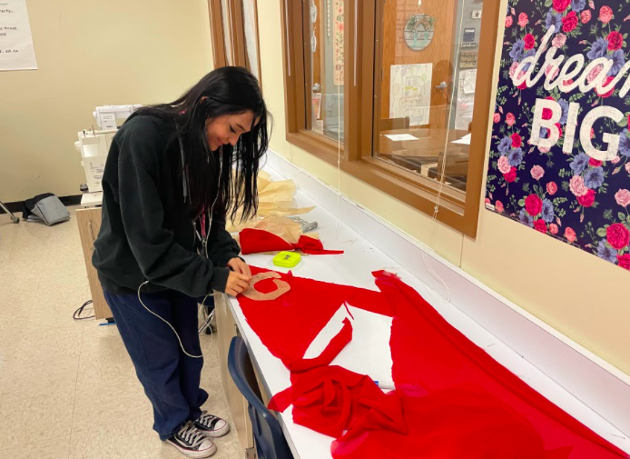 Sofie Gonzalez, junior, works on her red dress for the UIW competition