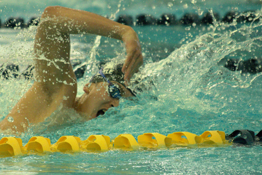Colin Doyle finishes his last leg of the 400 meter freestyle relay at the district championships on Jan 29.