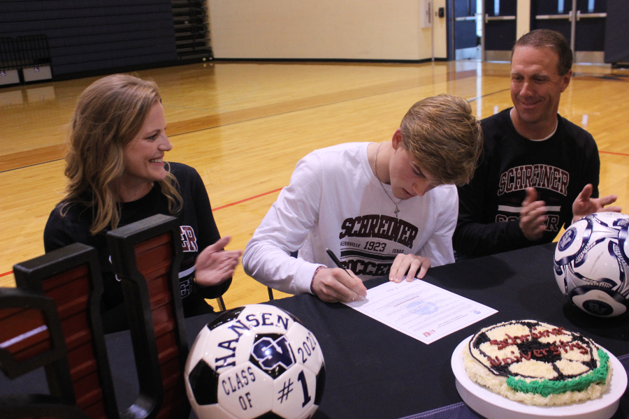 Cole Hansen signs his letter of intent to play soccer at Schreiner University.