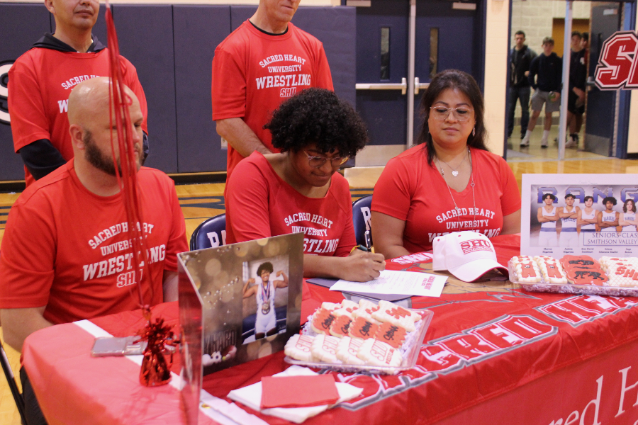 Selena Sifuentes Shaffer signs her letter of intent to wrestle for Sacred Heart University.