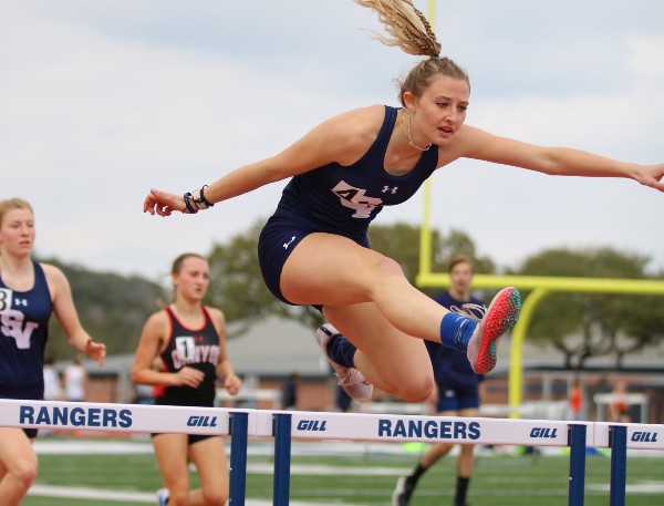Junior Zada Zimmerman jumps over a hurdle at the Ranger Relays. Zimmerman set her personal record for the 100-meter hurdles at the Texas Relays last weekend.
