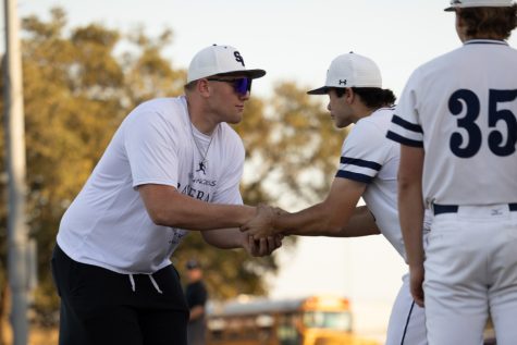 Colton Thomasson and Cooper Burgess shake hands before a matchup against New Braunfels on March 25.