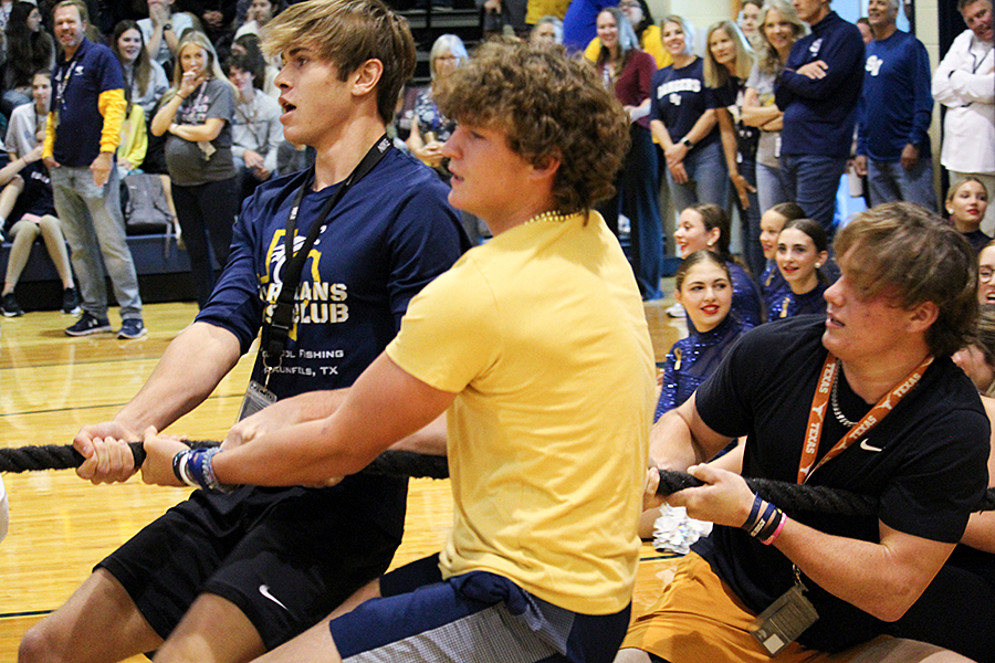 Juniors struggle to win the tug of war competition against the seniors.