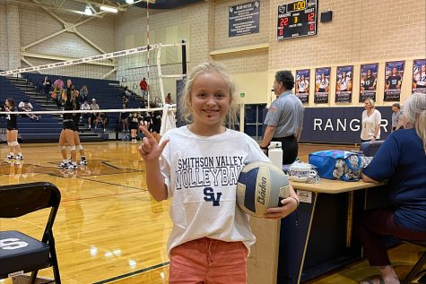 Henley Gieringer, 7, supports the high schools volleyball team.