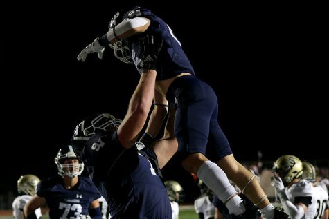 After a touchdown, senior Colton Thomasson lifts up sophomore Brad Sowersby.