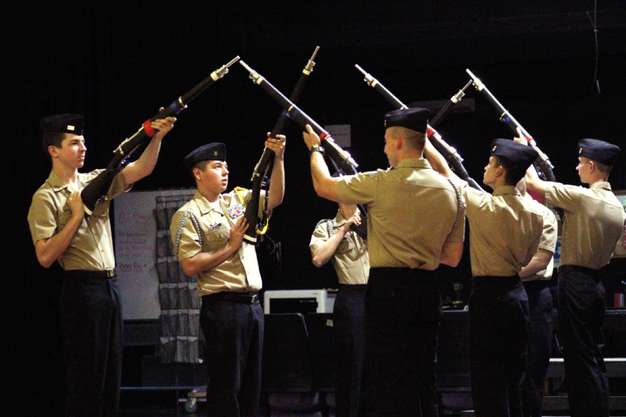 The ROTC armed drill team conducts a routine.
