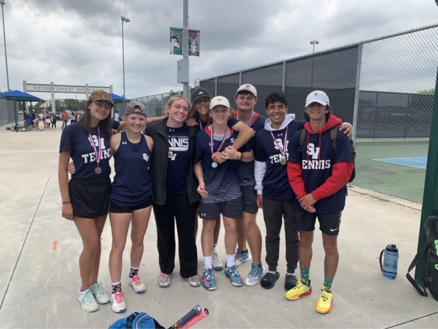 The boys varsity tennis team won first place at district. 