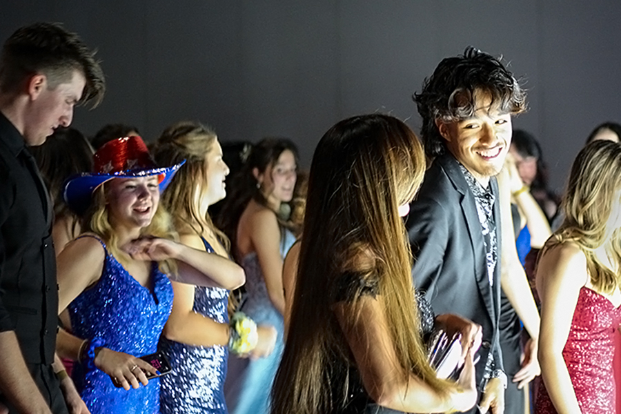 Senior Jay Butler line dances with the rest of the crowd during prom March 25 at the JW Marriott.