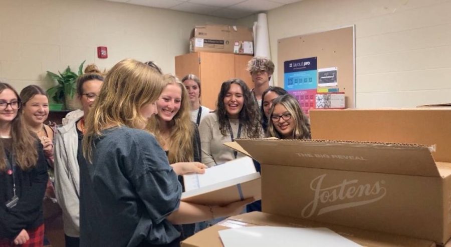Yearbook staff taking their first look at the yearbooks final product on May 10th 