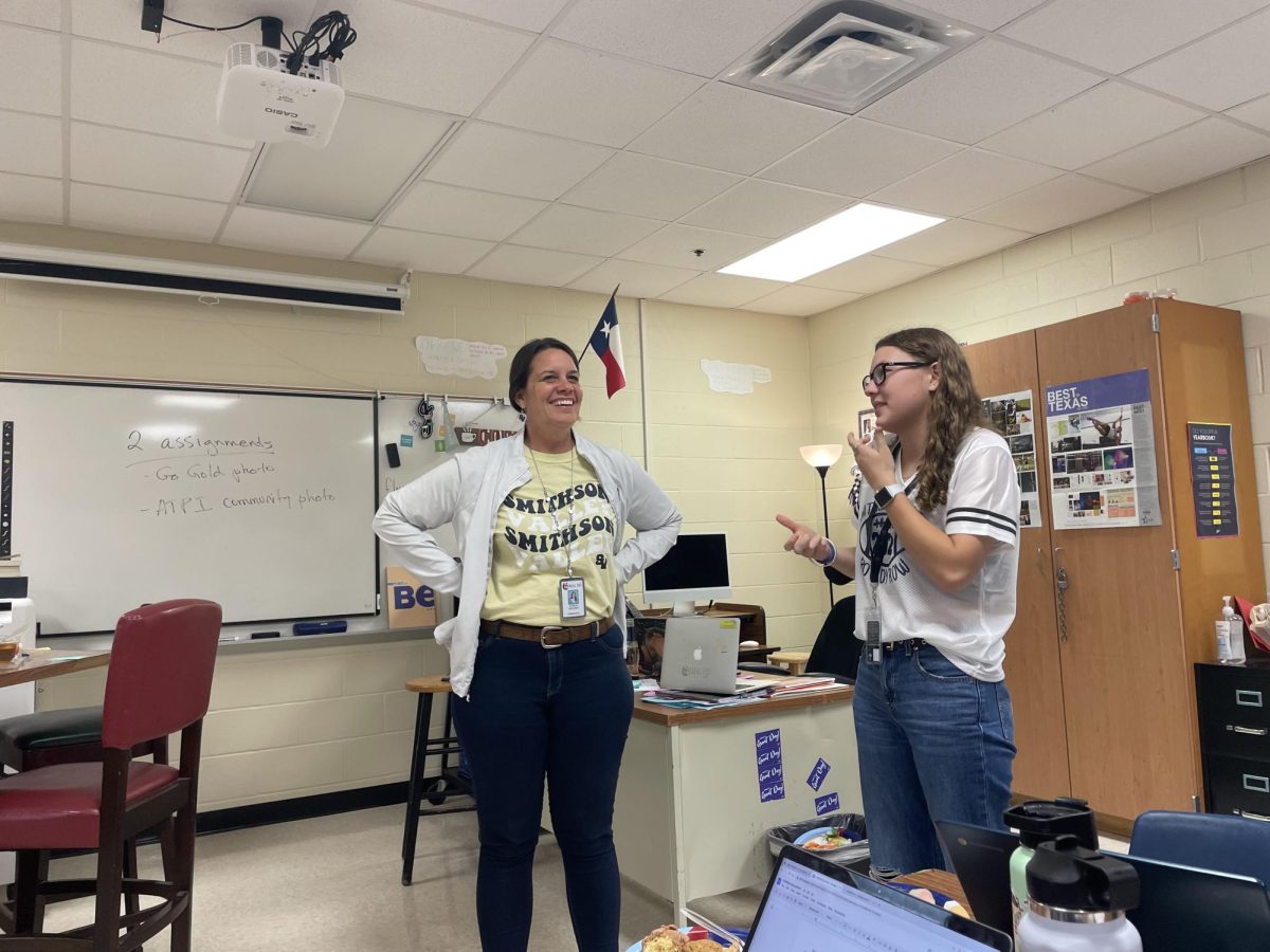 Editor-in-Chief Bethany Mann talks to Principal Stacia Snyder about cultural diversity day after serving her a plate of food.