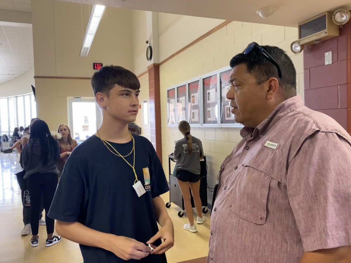 Assistant Principal Tony Trevino talks to sophomore Chad Rutten at lunch.