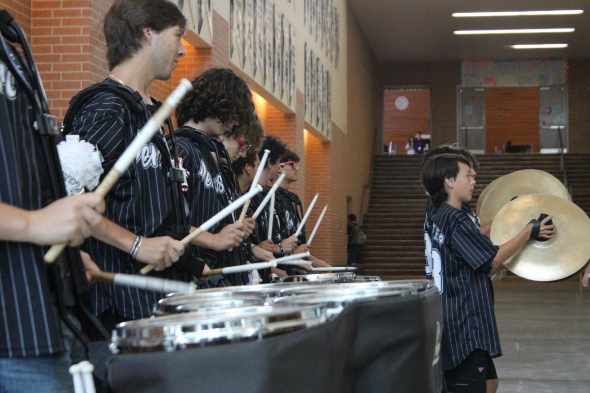 Drum line plays in the main hallway as students make their way to the pep rally.