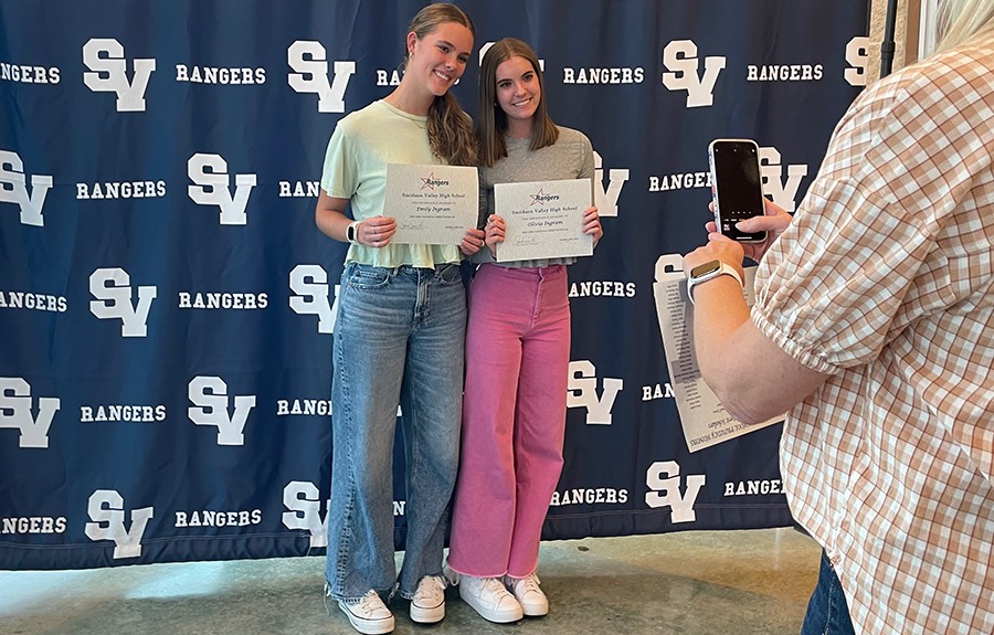 Holding their certificates, senior twin sisters Olivia Ingram and Emily Ingram both show off their award to the camera. 