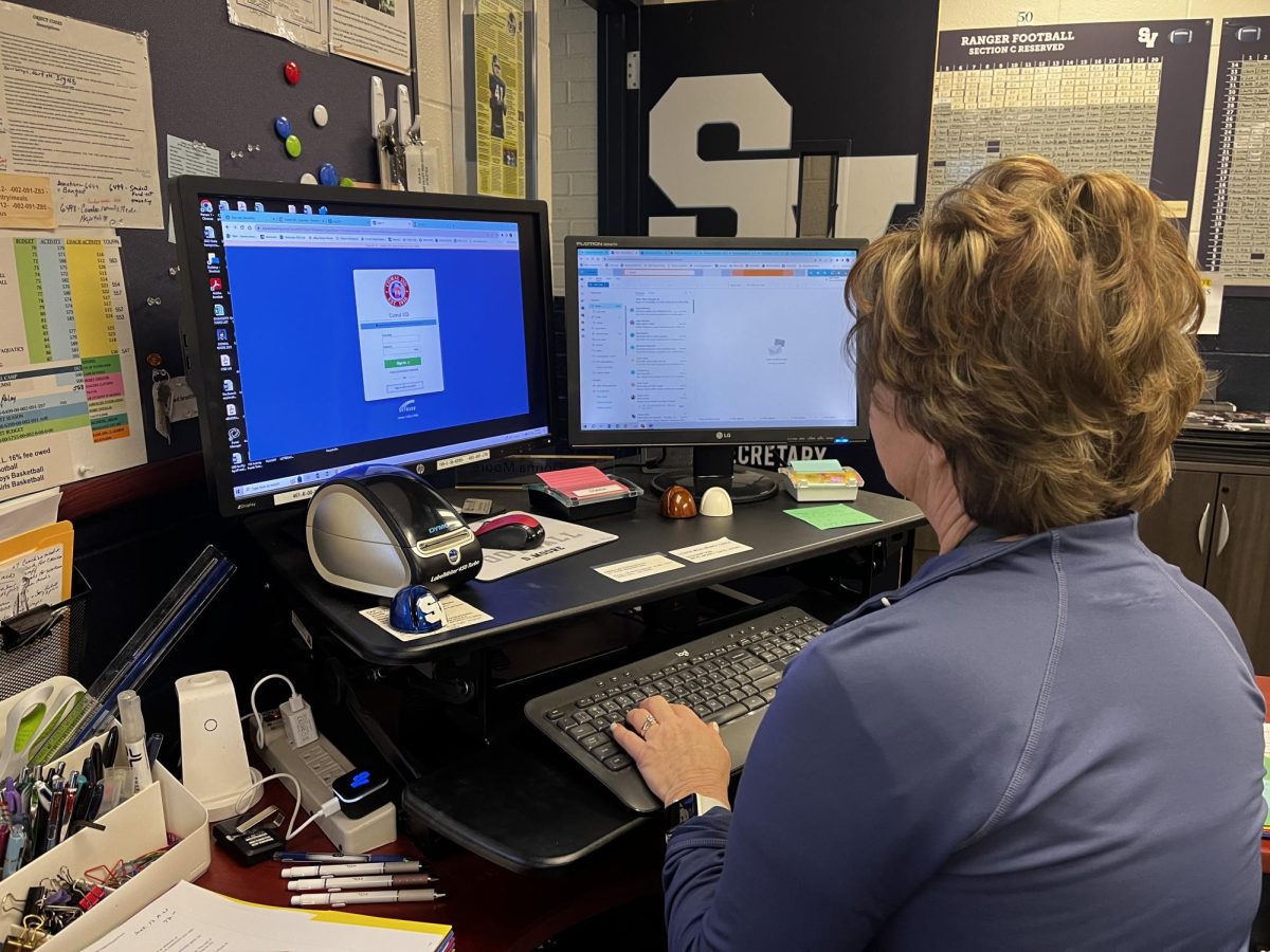 Athletic Secretary Donna Moore answers emails at her desk in preparation for Fridays state final football game against the Aledo Bearcats. 