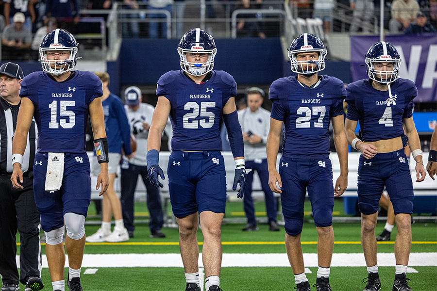 Seniors Ryland Walker, Jaxson Maynard, Nick Dudzikowski and Jackson Duffey walk across the field at AT&T Stadium Dec. 15 before the Class 5A Division II state championship. All four will be among 14 students who will sign their letters of intent in the main gym Wednesday at 8 a.m.