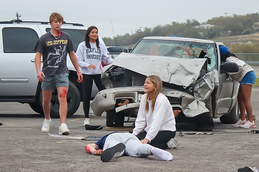 Seniors Ashlyn Mansfield and Victoria Williams talk to Senior Zach Gingrich in the car during the shattered dreams presentation on March 7.