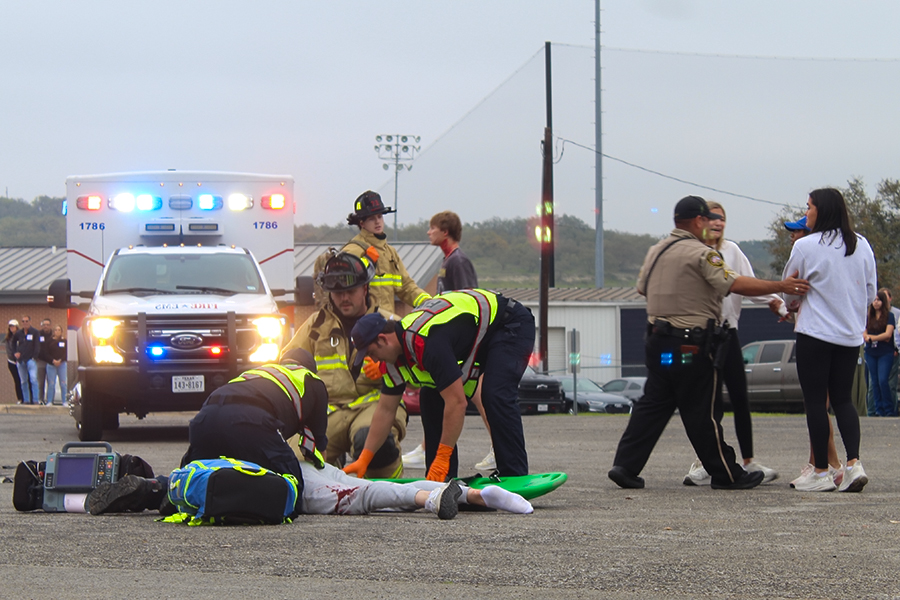 Local EMS workers move senior Maverick Minister onto a back board during the Shattered Dreams presentation March 7. They continued to do chest compression before pronouncing him dead.