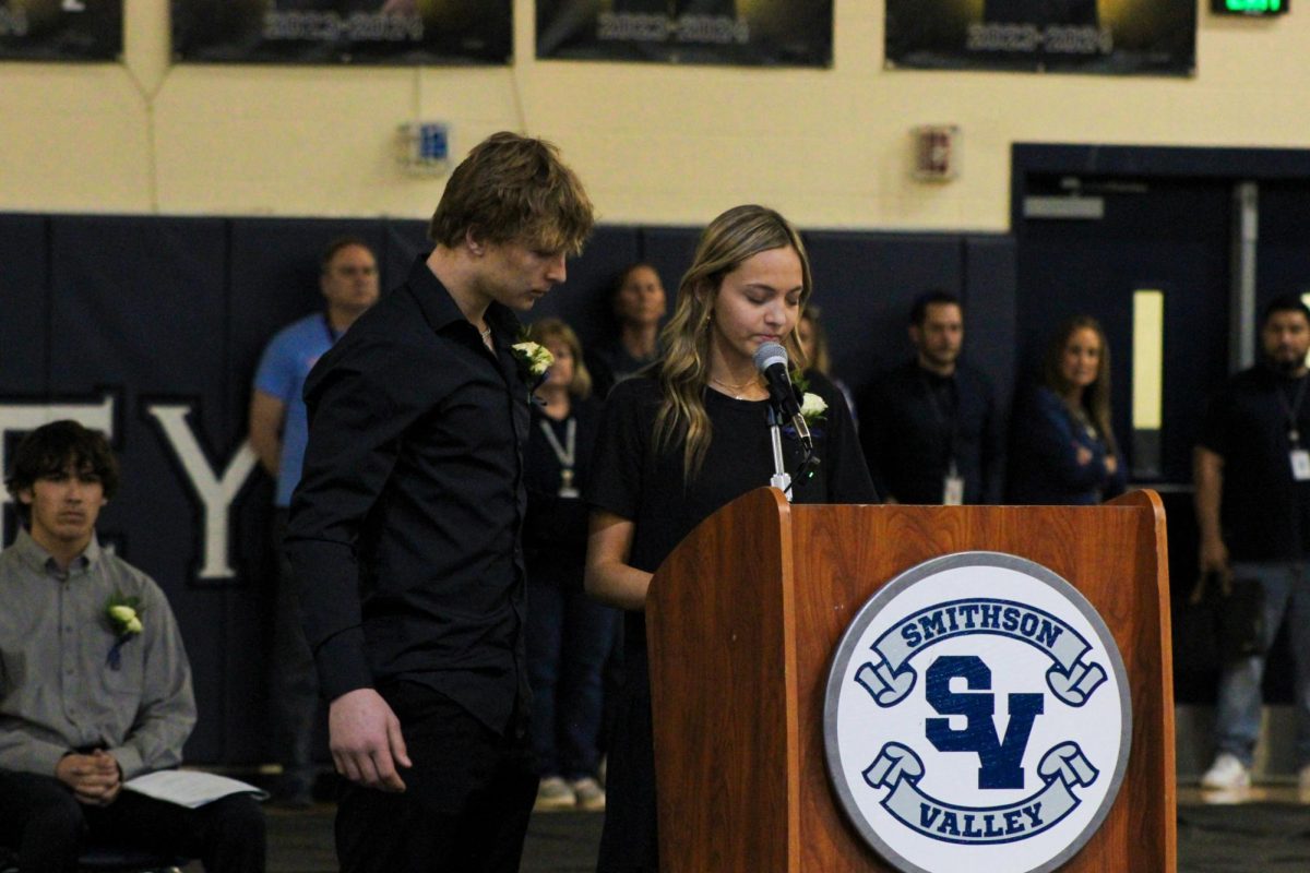 Senior Kannon Day comforts senior Karlie Jackson as she reads a poem at the Shattered Dreams memorial service. The mock funeral aimed to discourage impaired and reckless driving by showing the impact it has on family and friends. 