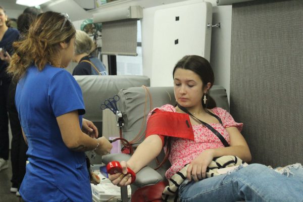 Senior Hannah Pape gives blood during the last blood drive on February 1.